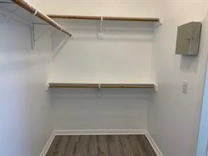 a view of walk in closet with empty racks