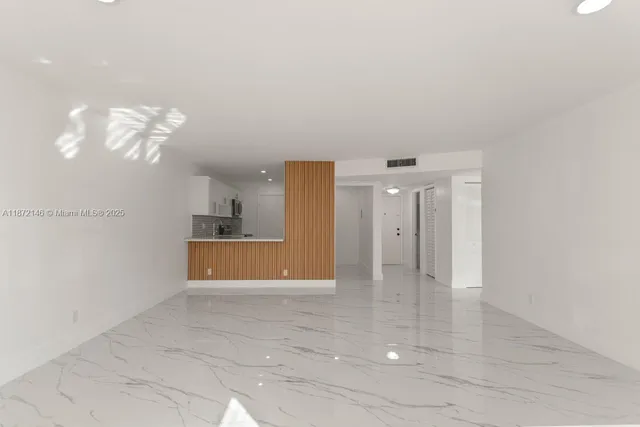 a view of a hallway with a bathroom