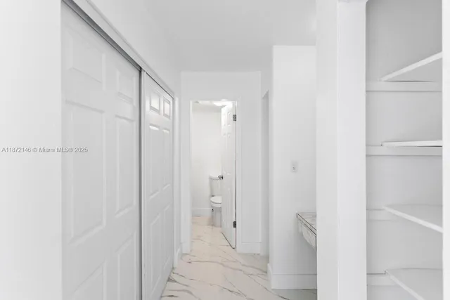 a bathroom with a shower and a glass door