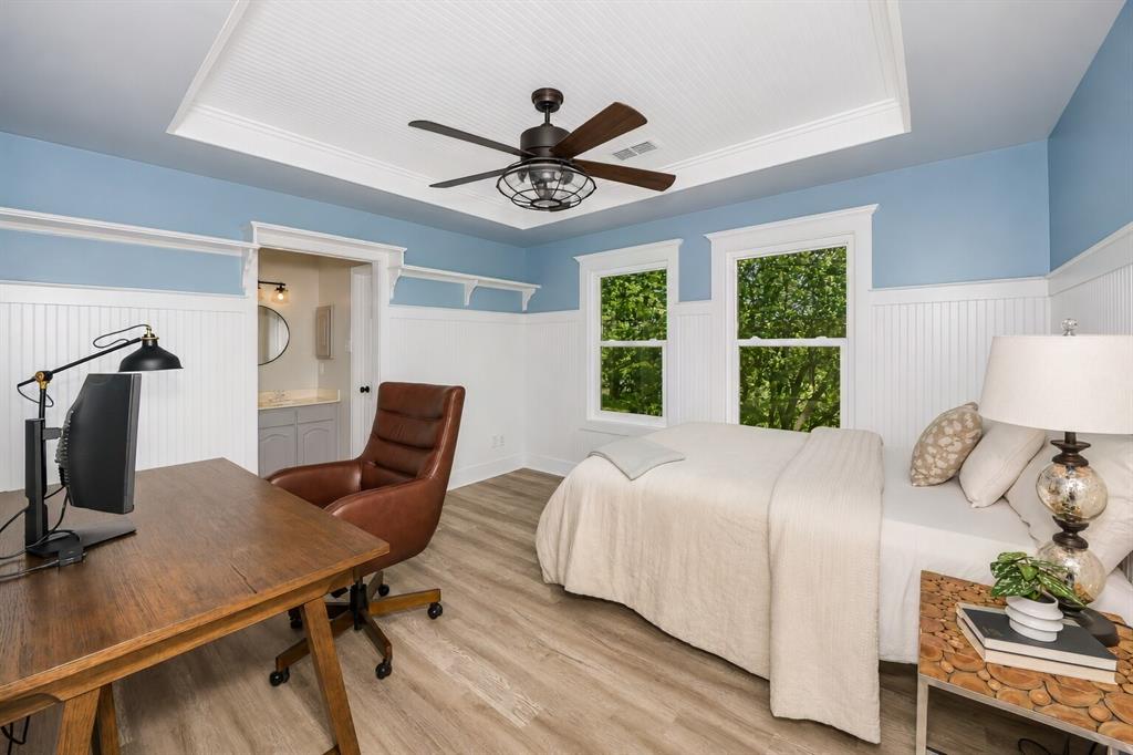 3817 Ganzer Road West Denton, TX 76207 - Photo 21 of 40 Bright and inviting, this secondary bedroom blends modern farmhouse trim with large windows that pull in soft natural light throughout the day. The layout feels flexible — just the right size for a teen retreat, a cozy guest room, or a quiet study space tucked away from the main living areas. Direct access to the Jack-and-Jill bath gives the room a comfortable, connected feel, making it a standout space for anyone who wants privacy without feeling closed off.