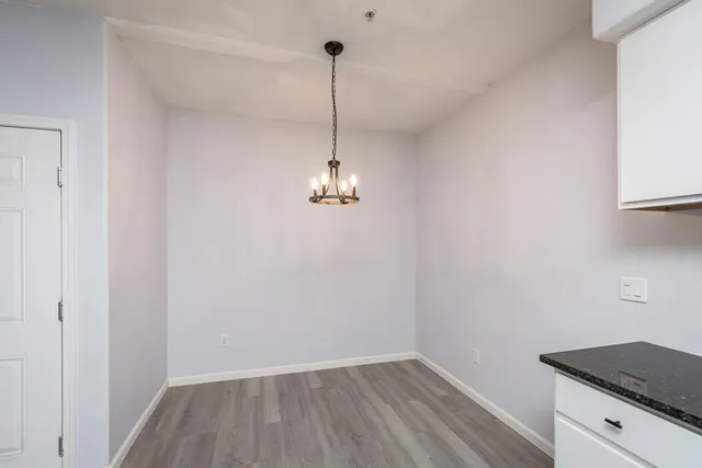 a view of a room with wooden floor closet and a window