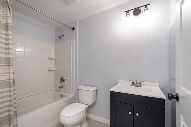 a bathroom with a sink toilet a mirror and shower