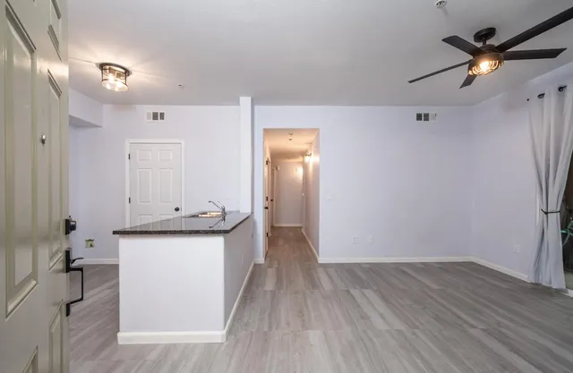 a view of a kitchen with a sink and wooden floor