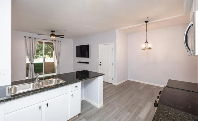 a spacious bathroom with a granite countertop sink a mirror and shower