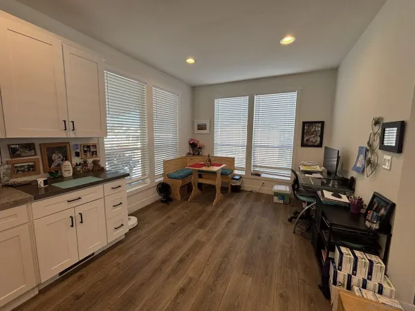a living room with furniture and wooden floor