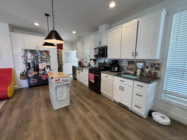 a kitchen with stove and cabinets