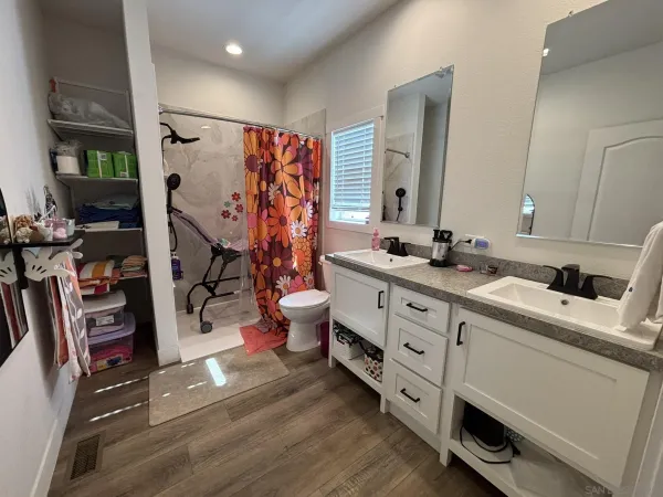 a bathroom with double vanity and a bathtub