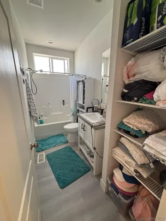 a living room with furniture and a painting on the wall