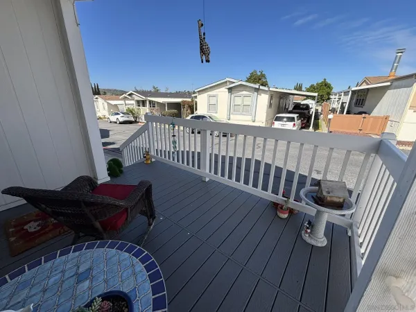 a view of a balcony with chair and wooden floor