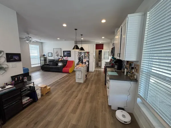 a living room with furniture and wooden floor