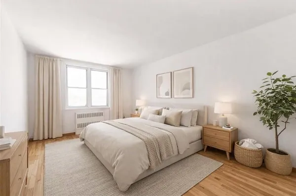 a bedroom with a large bed and a large window