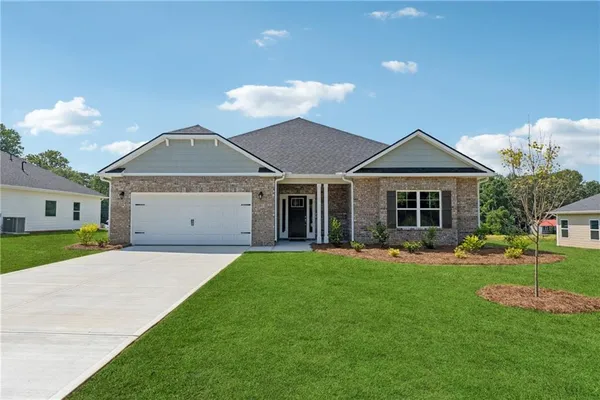 a front view of a house with a yard and garage