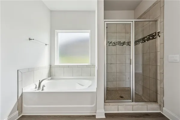 a bathroom with a bathtub and a shower