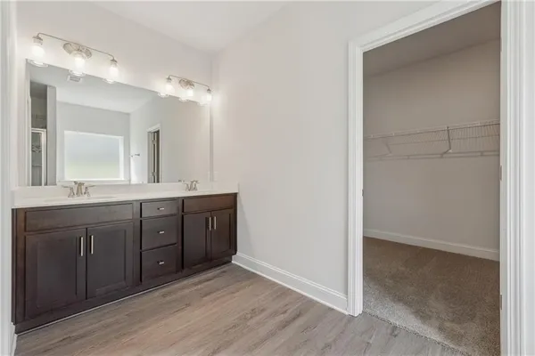 a spacious bathroom with a double vanity sink and a mirror
