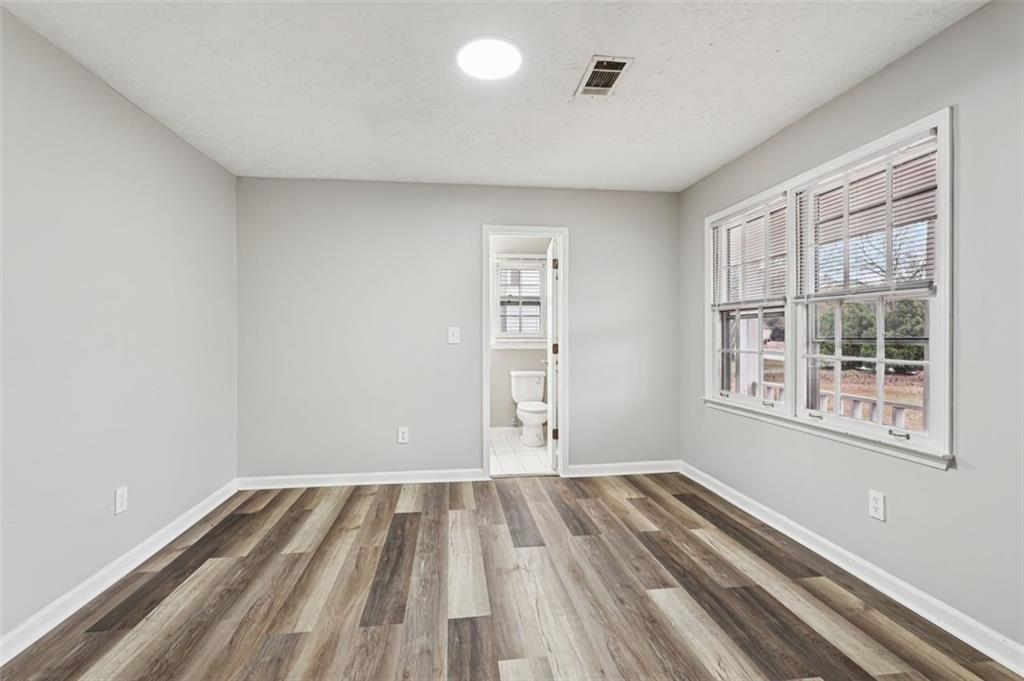 5151 Lilburn Stone Mountain Road Lilburn, GA 30047 - Photo 25 of 58 a view of a room with wooden floor and windows