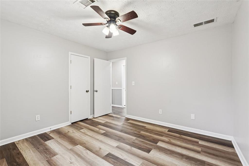 5151 Lilburn Stone Mountain Road Lilburn, GA 30047 - Photo 31 of 58 a view of a room with a ceiling fan