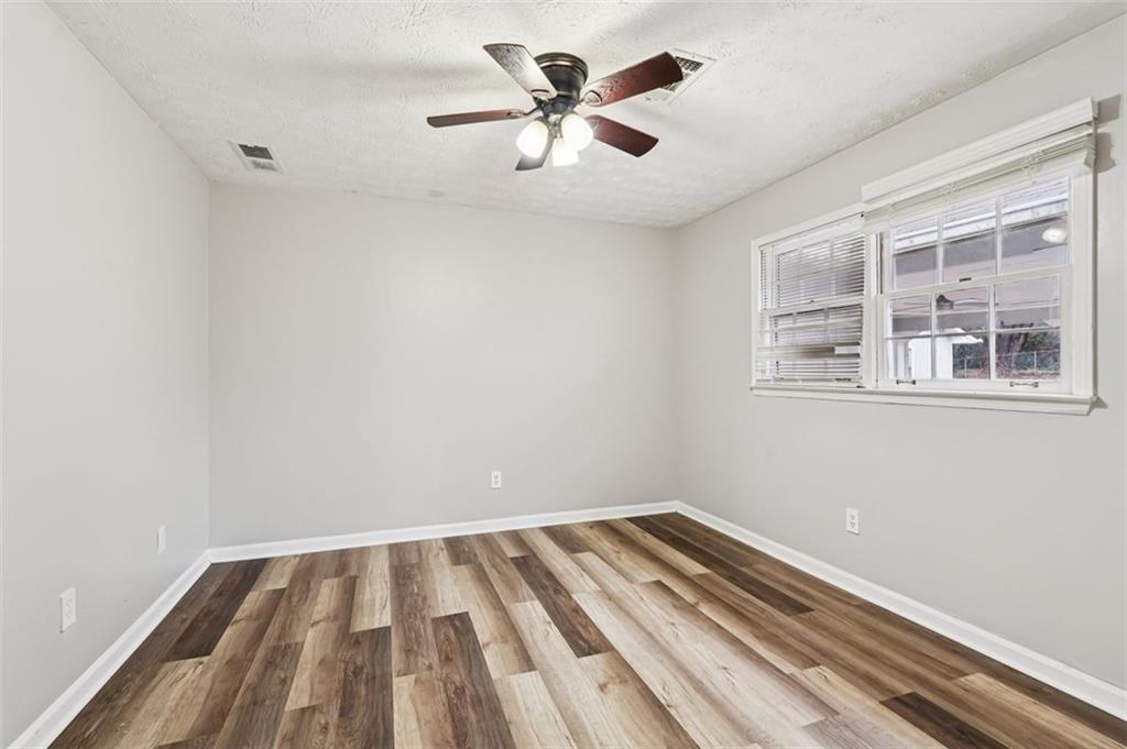 5151 Lilburn Stone Mountain Road Lilburn, GA 30047 - Photo 32 of 58 a view of room with a ceiling fan