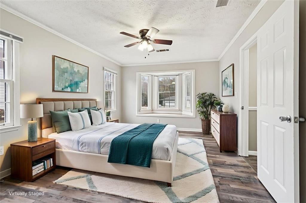 5151 Lilburn Stone Mountain Road Lilburn, GA 30047 - Photo 34 of 58 a bedroom with a large bed and a chandelier