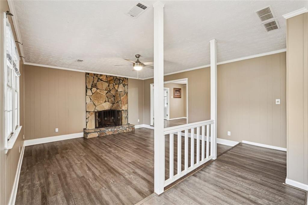 5151 Lilburn Stone Mountain Road Lilburn, GA 30047 - Photo 4 of 58 a view of an empty room with wooden floor