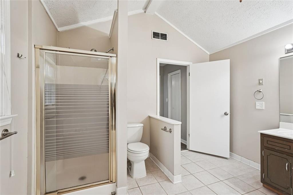 5151 Lilburn Stone Mountain Road Lilburn, GA 30047 - Photo 44 of 58 a bathroom with a toilet and a shower