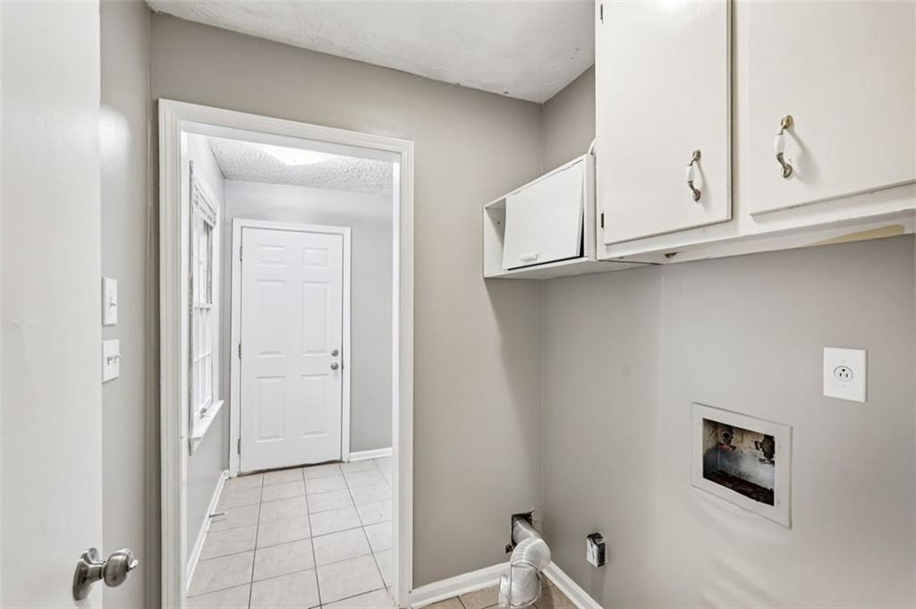 5151 Lilburn Stone Mountain Road Lilburn, GA 30047 - Photo 45 of 58 a view of a kitchen with cabinets and a wooden floor