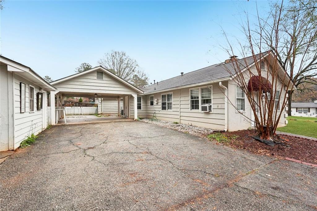 5151 Lilburn Stone Mountain Road Lilburn, GA 30047 - Photo 50 of 58 a front view of a house with a garden