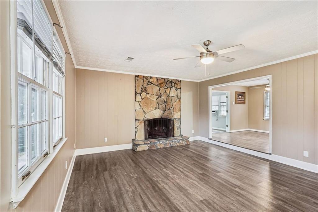 5151 Lilburn Stone Mountain Road Lilburn, GA 30047 - Photo 5 of 58 wooden floor in an empty room with a window