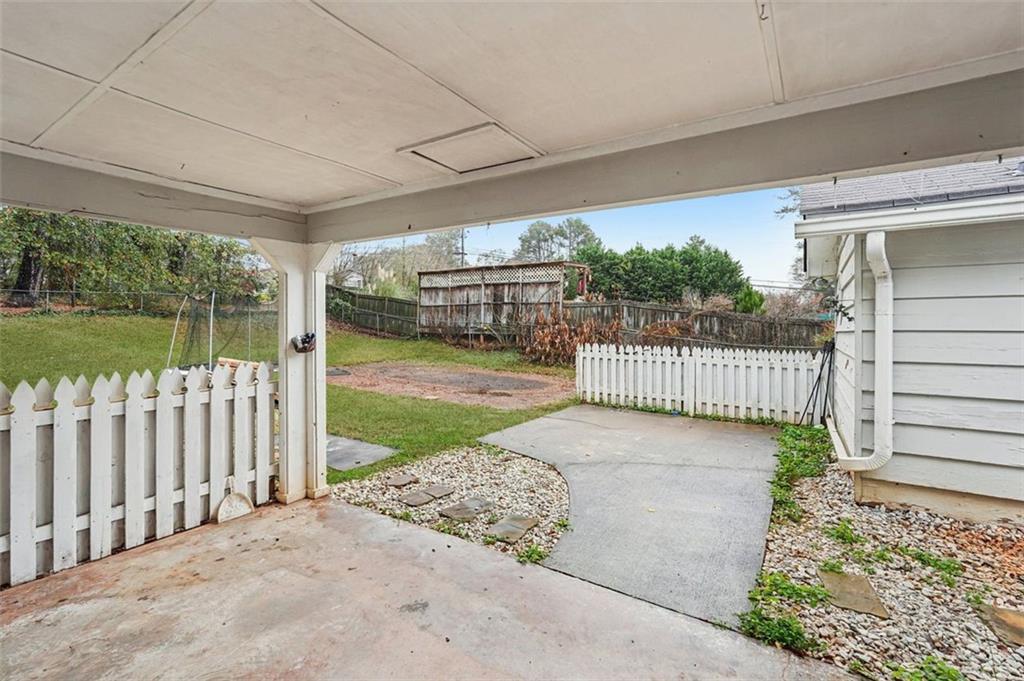 5151 Lilburn Stone Mountain Road Lilburn, GA 30047 - Photo 52 of 58 a view of a porch with wooden floor and floor to ceiling window