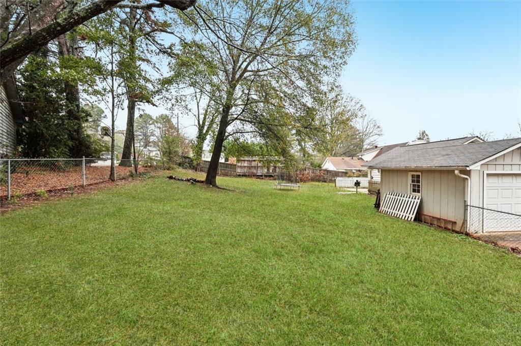 5151 Lilburn Stone Mountain Road Lilburn, GA 30047 - Photo 57 of 58 a view of a house with a yard