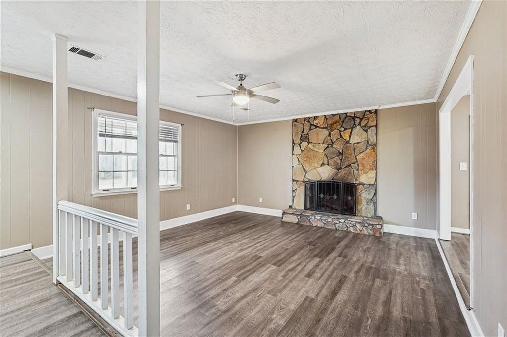 5151 Lilburn Stone Mountain Road Lilburn, GA 30047 - Photo 6 of 58 a view of an empty room with a window and fireplace