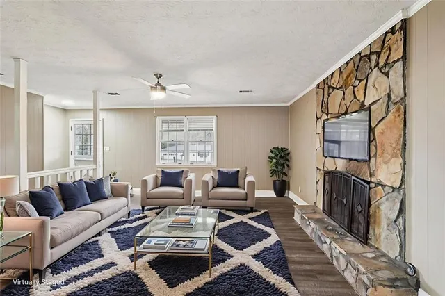 a living room with furniture ceiling fan and a rug