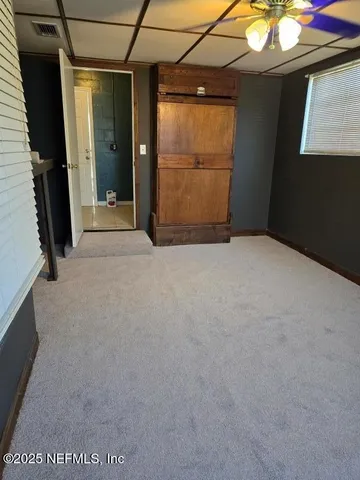 a view of an empty room with a window