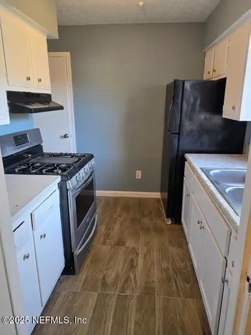 a kitchen with a stove and a refrigerator