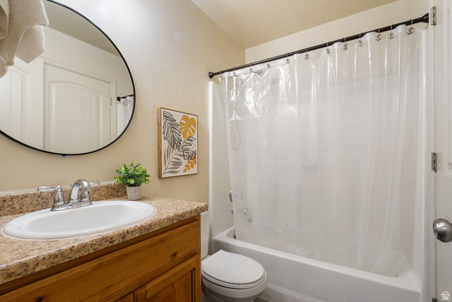 1393 West 150 North Springville, UT 84663 - Photo 18 of 31 Bathroom featuring a wood-finish vanity with a built-in sink and mottled countertop