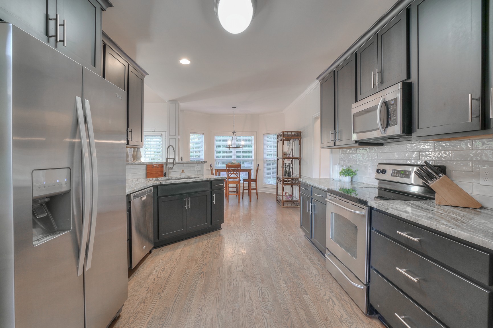1211 Marathon Drive Murfreesboro, TN 37129 - Photo 19 of 37 a kitchen with stainless steel appliances granite countertop a refrigerator a sink dishwasher a stove and white countertops with wooden floor