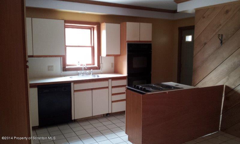 4170 Madisonville Road Moscow, PA 18444 - Photo 5 of 19 a kitchen with a stove a refrigerator and a sink