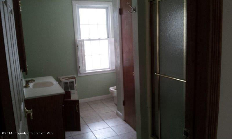 4170 Madisonville Road Moscow, PA 18444 - Photo 7 of 19 a bathroom with a sink a toilet and a window
