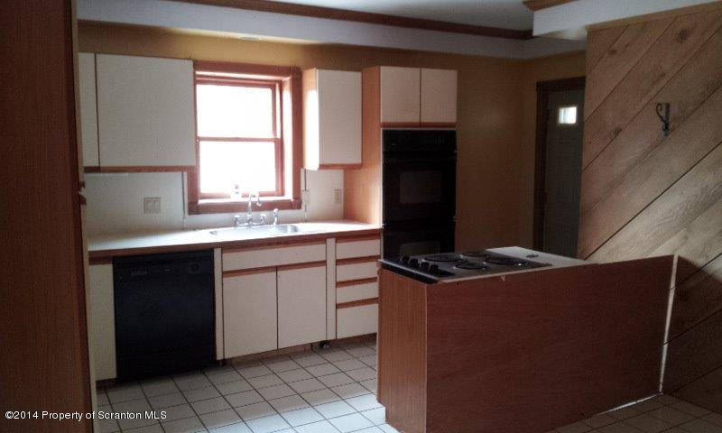4170 Madisonville Road Moscow, PA 18444 - Photo 10 of 19 a kitchen with a stove a refrigerator and a sink