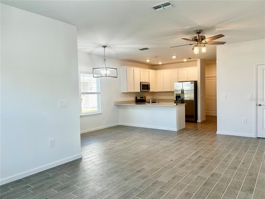 3514 Southeast 37th Ave Road Ocala, FL 34480 - Photo 16 of 42 a view of a kitchen with a sink and a refrigerator