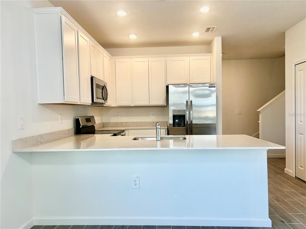 3514 Southeast 37th Ave Road Ocala, FL 34480 - Photo 17 of 42 a large kitchen with stainless steel appliances and a refrigerator