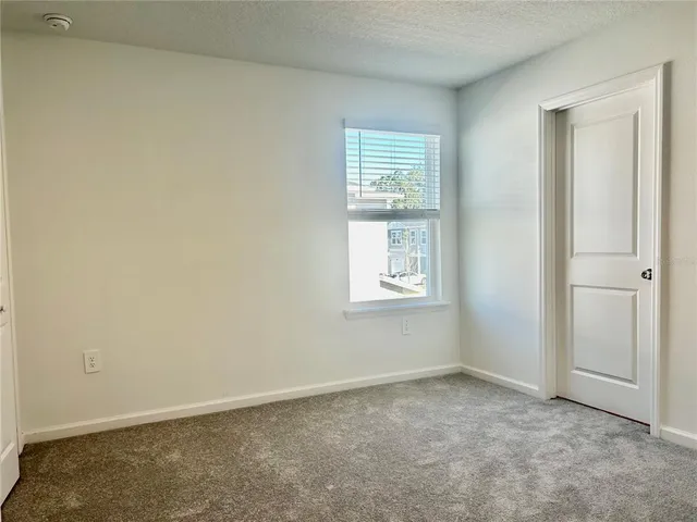 an empty room with closet area