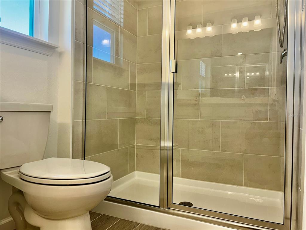 3514 Southeast 37th Ave Road Ocala, FL 34480 - Photo 37 of 42 a bathroom with a toilet and a shower