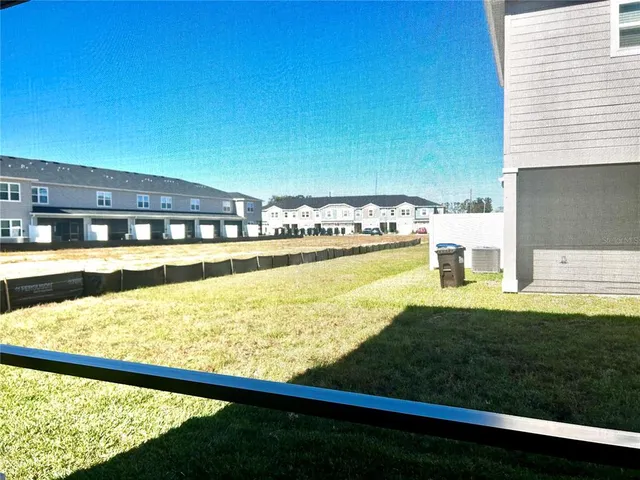 a view of house with backyard