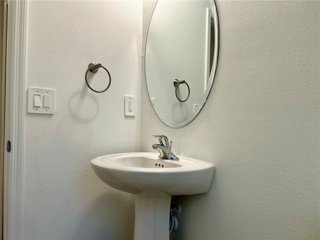 3514 Southeast 37th Ave Road Ocala, FL 34480 - Photo 10 of 42 a bathroom with a sink and a mirror