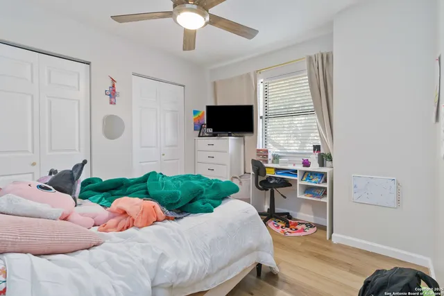 a bedroom with furniture and a flat screen tv
