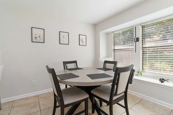 a view of a dining room with furniture and window