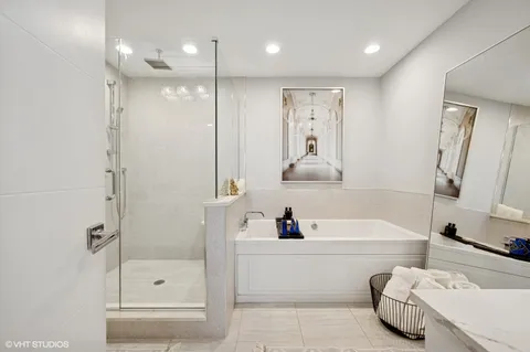 a bathroom with a tub a sink and a shower