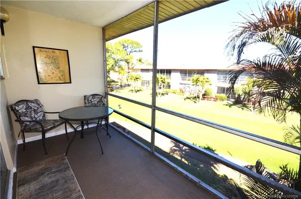 a view of a chairs and table in a balcony
