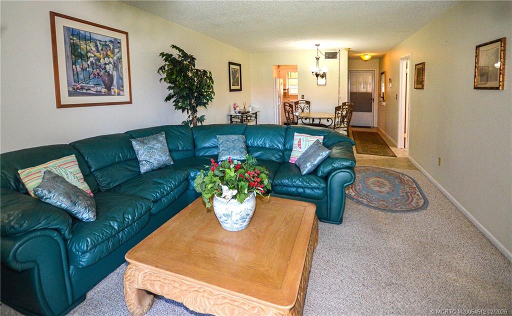 1963 Southwest Palm City Road, Unit F Stuart, FL 34994 - Photo 2 of 19 a living room with furniture flowerpot and window
