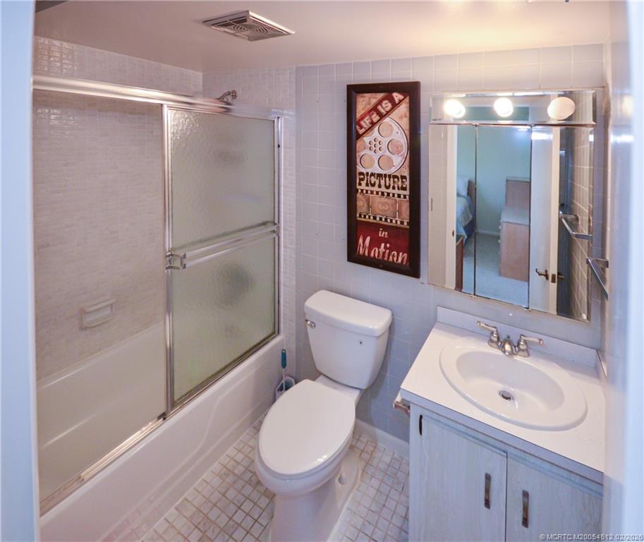 1963 Southwest Palm City Road, Unit F Stuart, FL 34994 - Photo 10 of 19 a bathroom with a sink toilet and shower
